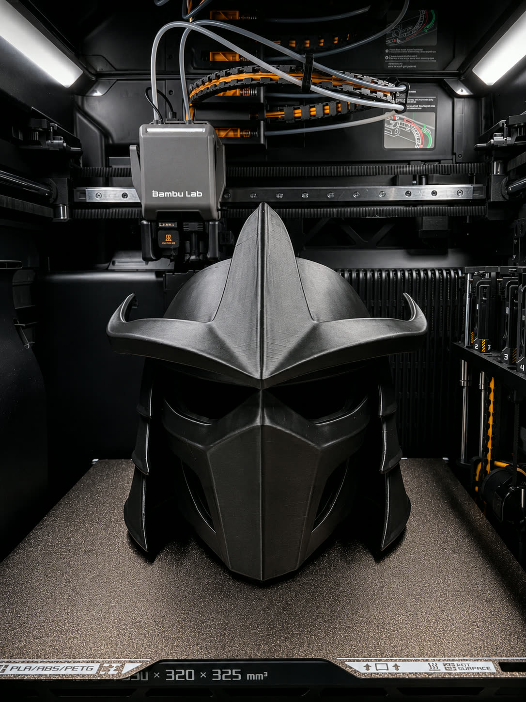 Silver 3D printed bladed helmet with a menacing face plate