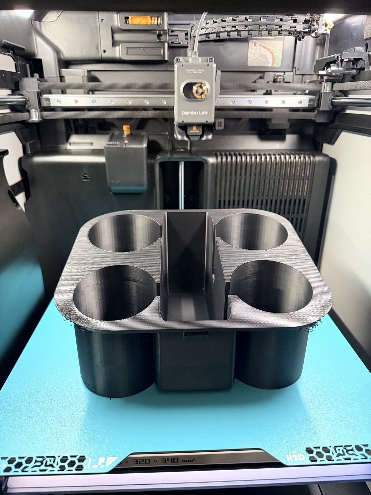 Black four-compartment printed organizer on the printer bed