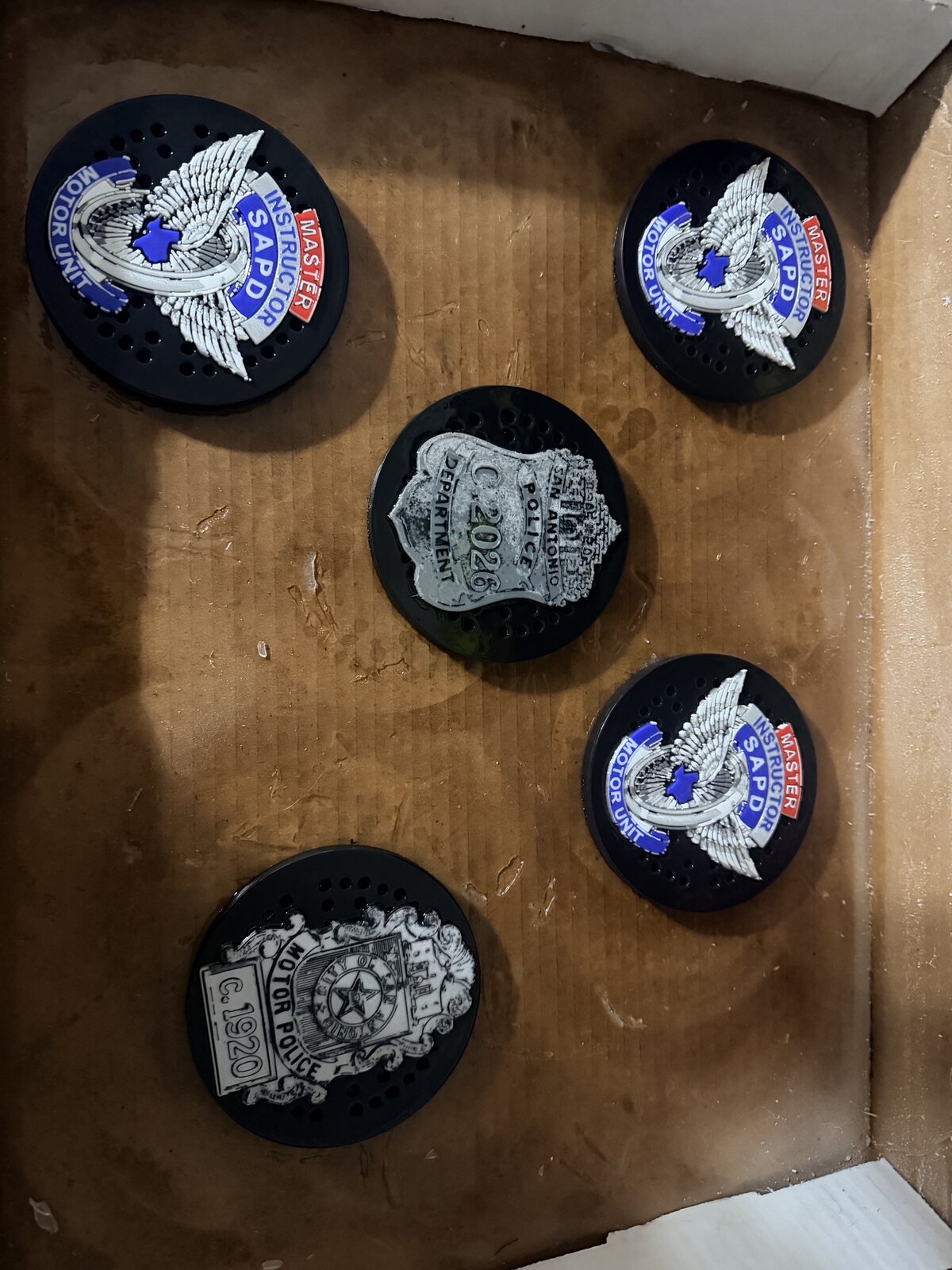 Custom police siren covers with unit insignias displayed together