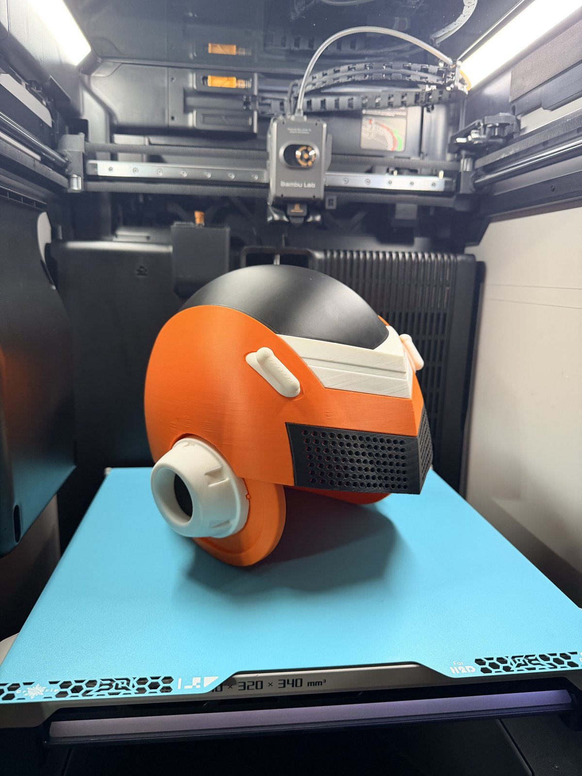 Orange sci-fi helmet seen from the rear with printed vents