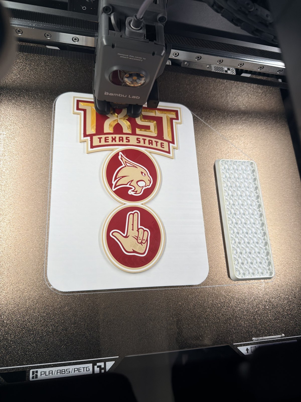 Layered red and white printed sports signs on the printer bed