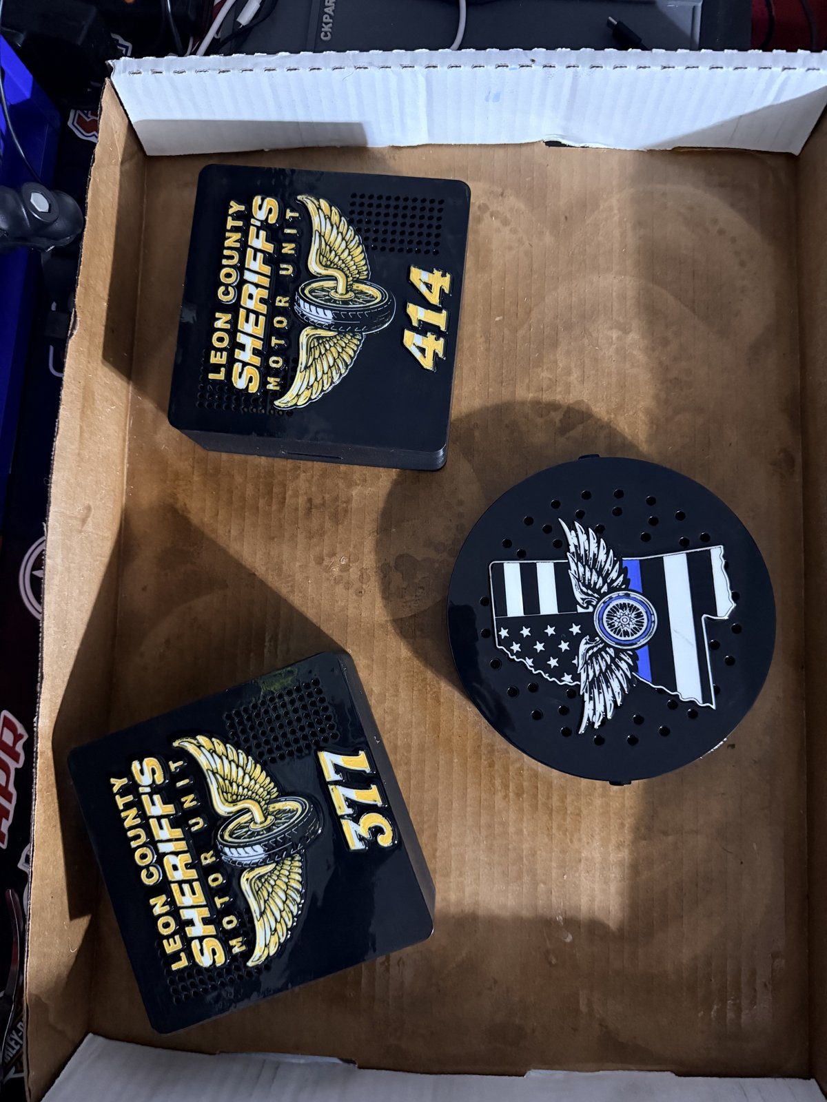 Custom black siren covers with gold unit identification