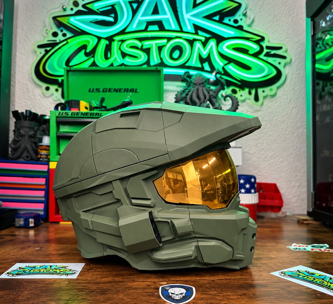 Olive green sci-fi helmet with gold visor, side view