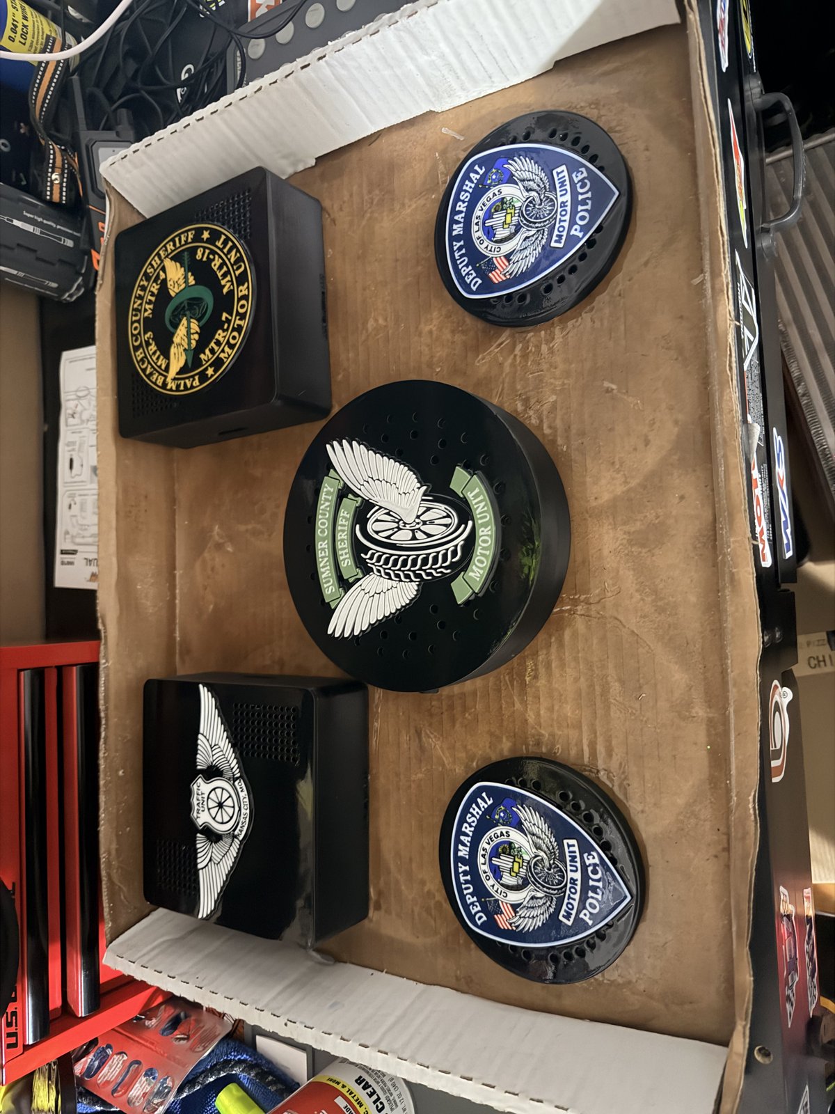 Custom siren covers with green and blue police emblems