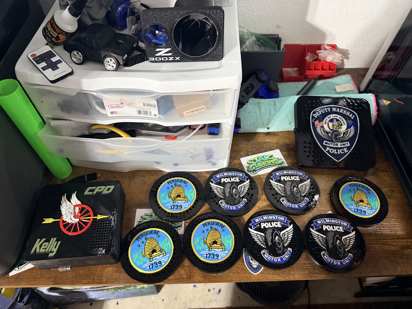 Completed set of custom unit siren covers displayed beside the printer