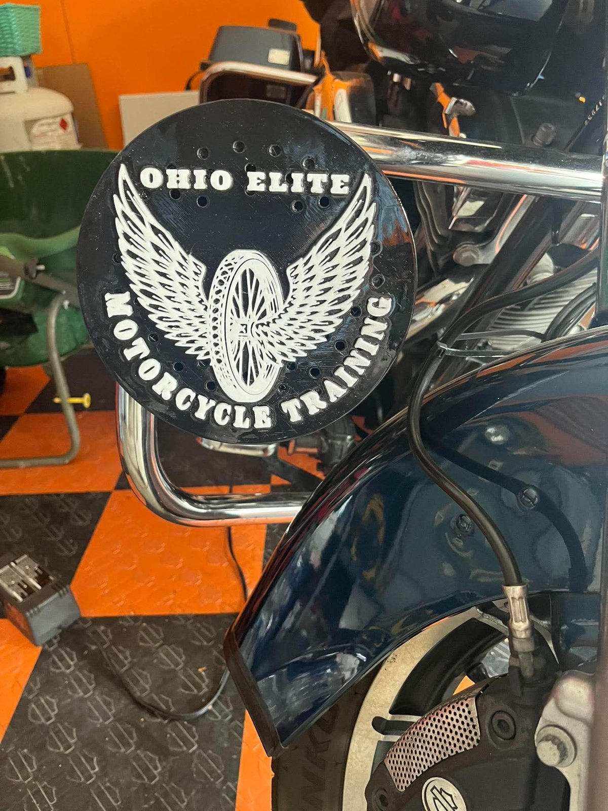 Winged motorcycle unit siren cover installed on a police bike