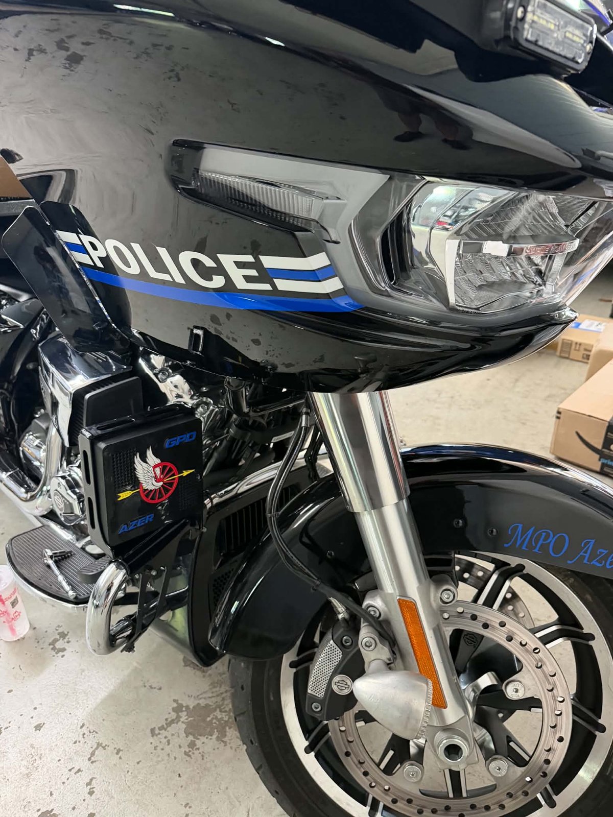 Custom siren cover mounted on the front of a police motorcycle