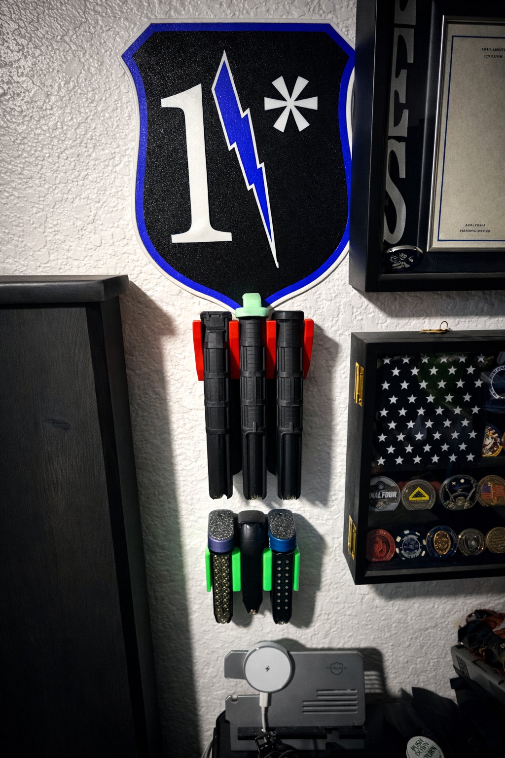 Illuminated number one wall sign above a collection of custom printed parts