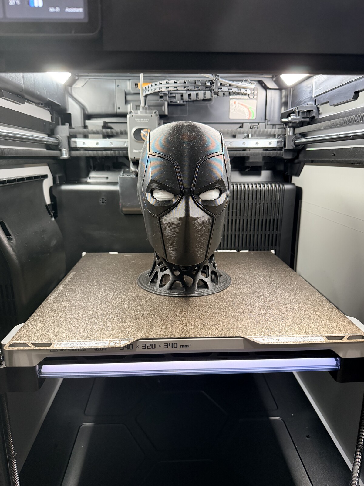 Metallic silver alien bust with a smooth elongated skull