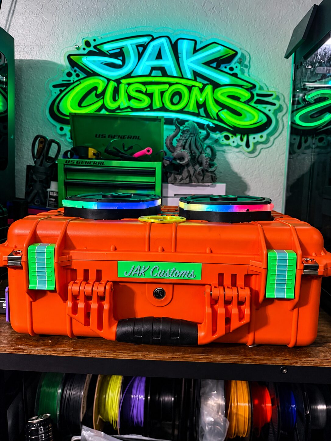 Orange carry case with green latches and a personalized front panel