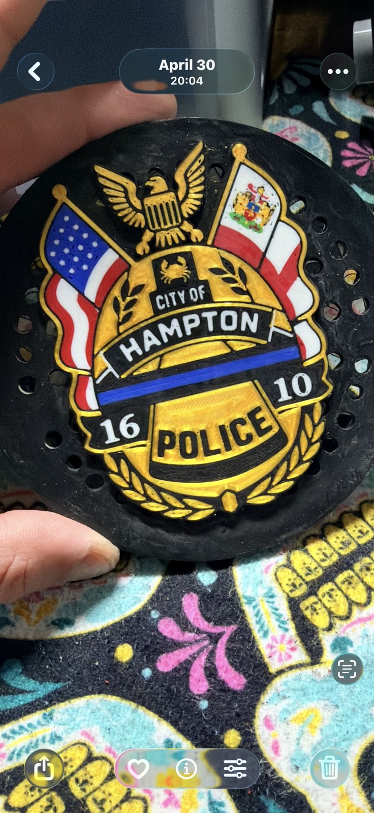 Close-up of a gold and black police unit siren cover