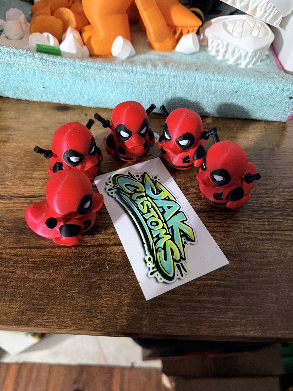 Red and black mini figures lined up on a workbench