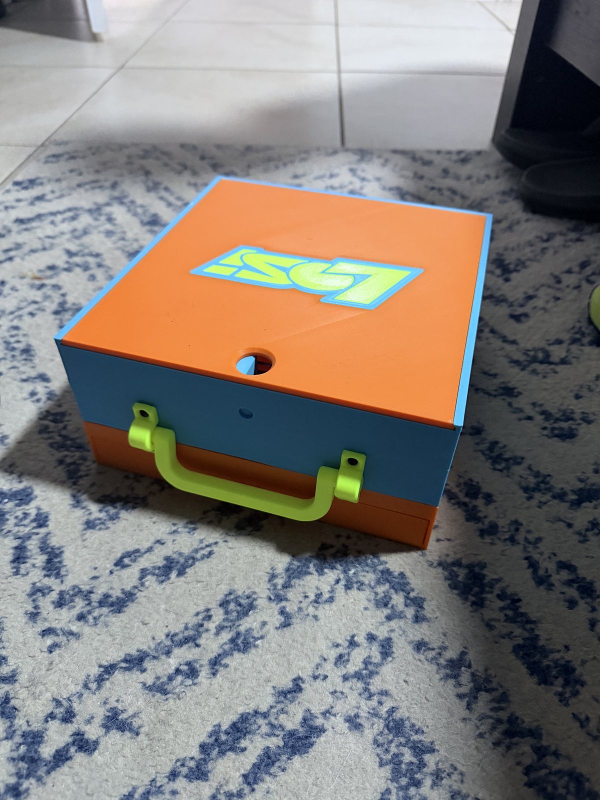 Orange and green printed storage box with a fitted lid