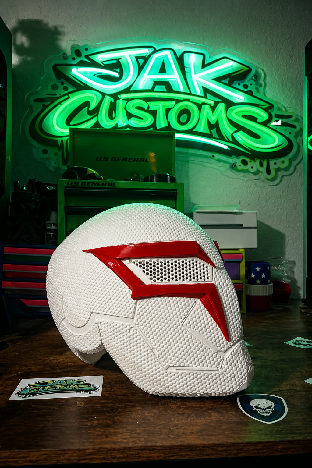 White and red painted 3D printed helmet on a workbench
