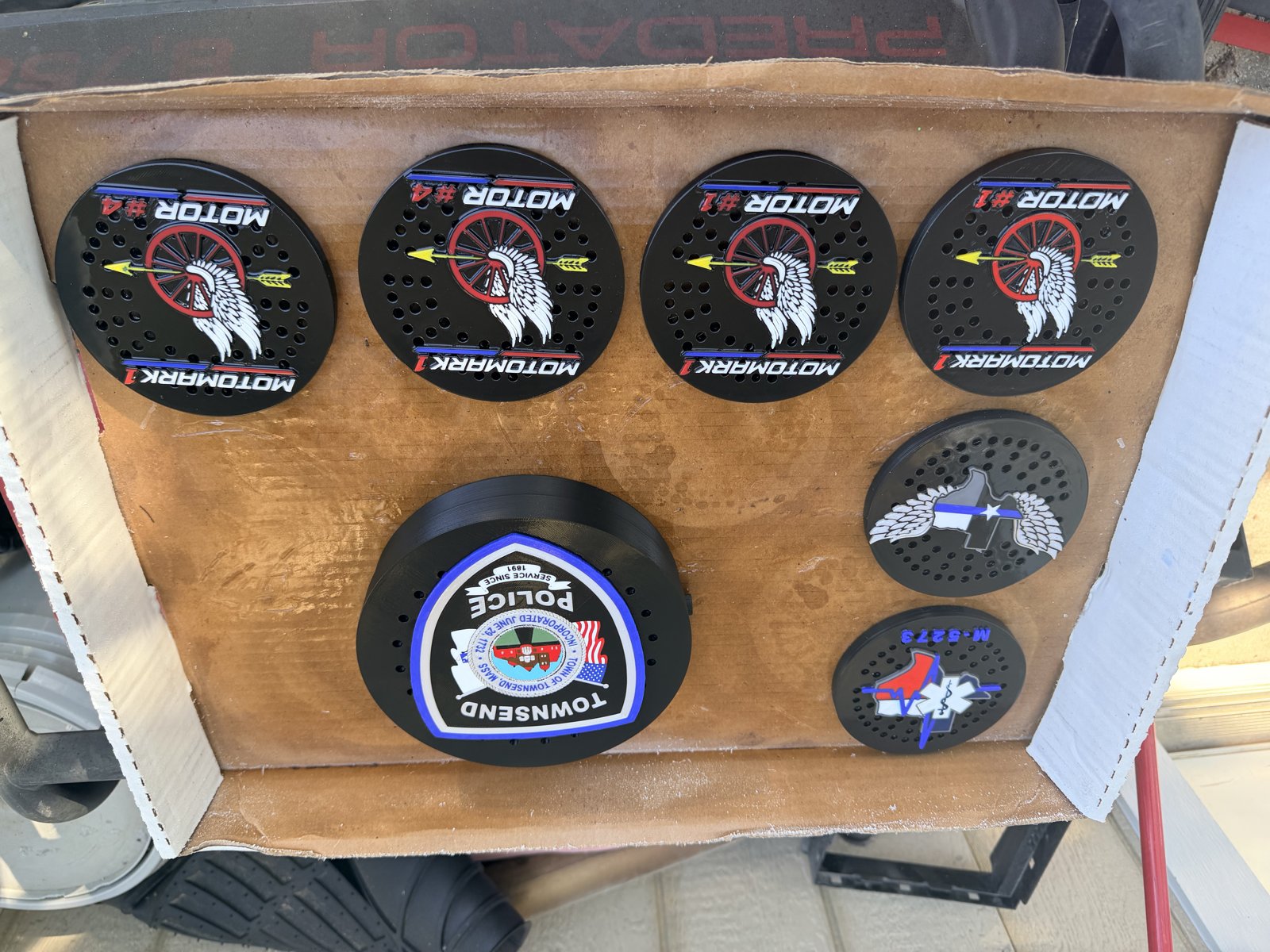 Six custom department and unit siren covers displayed in a box