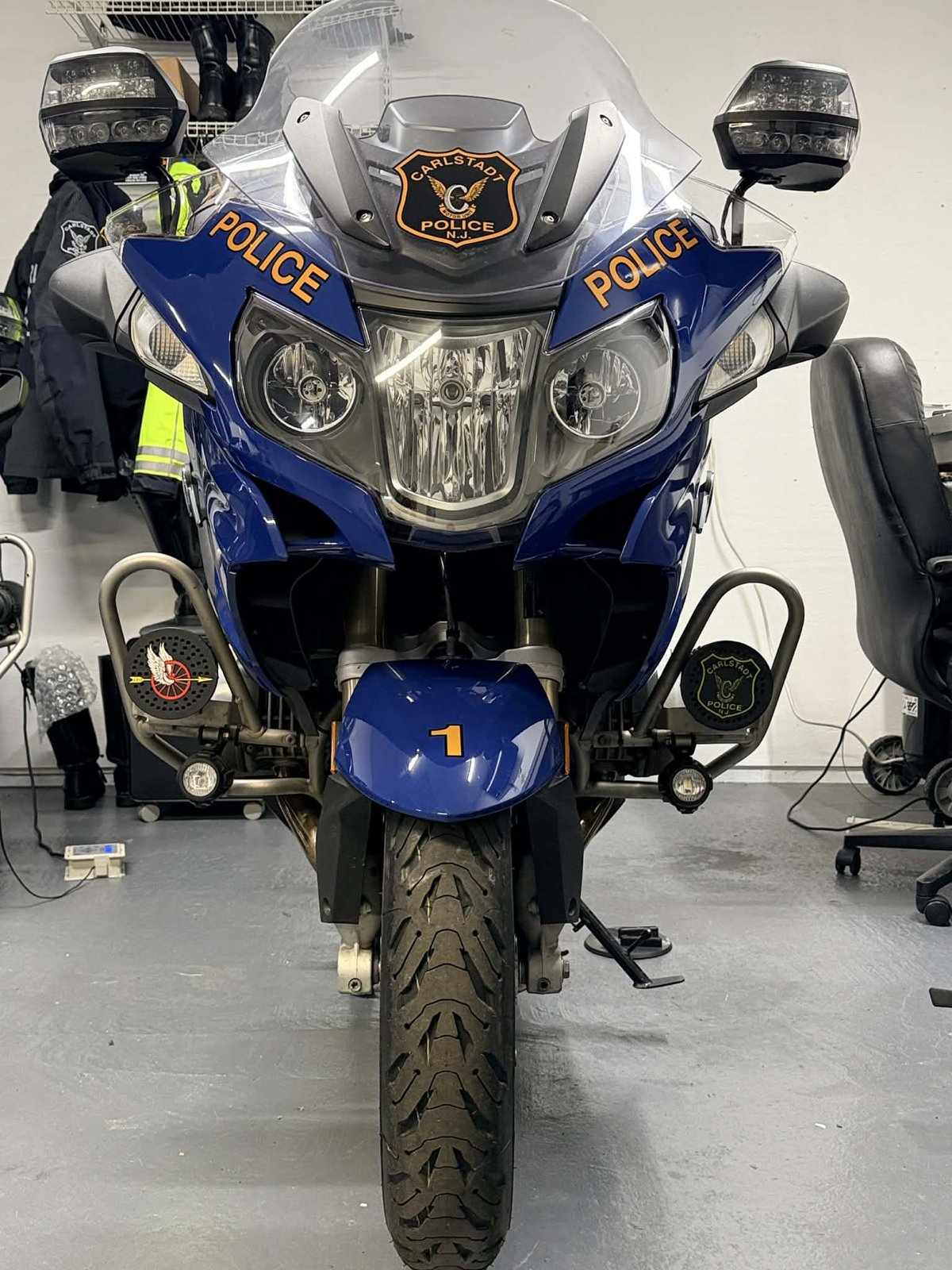 Front view of a police motorcycle with custom siren covers installed