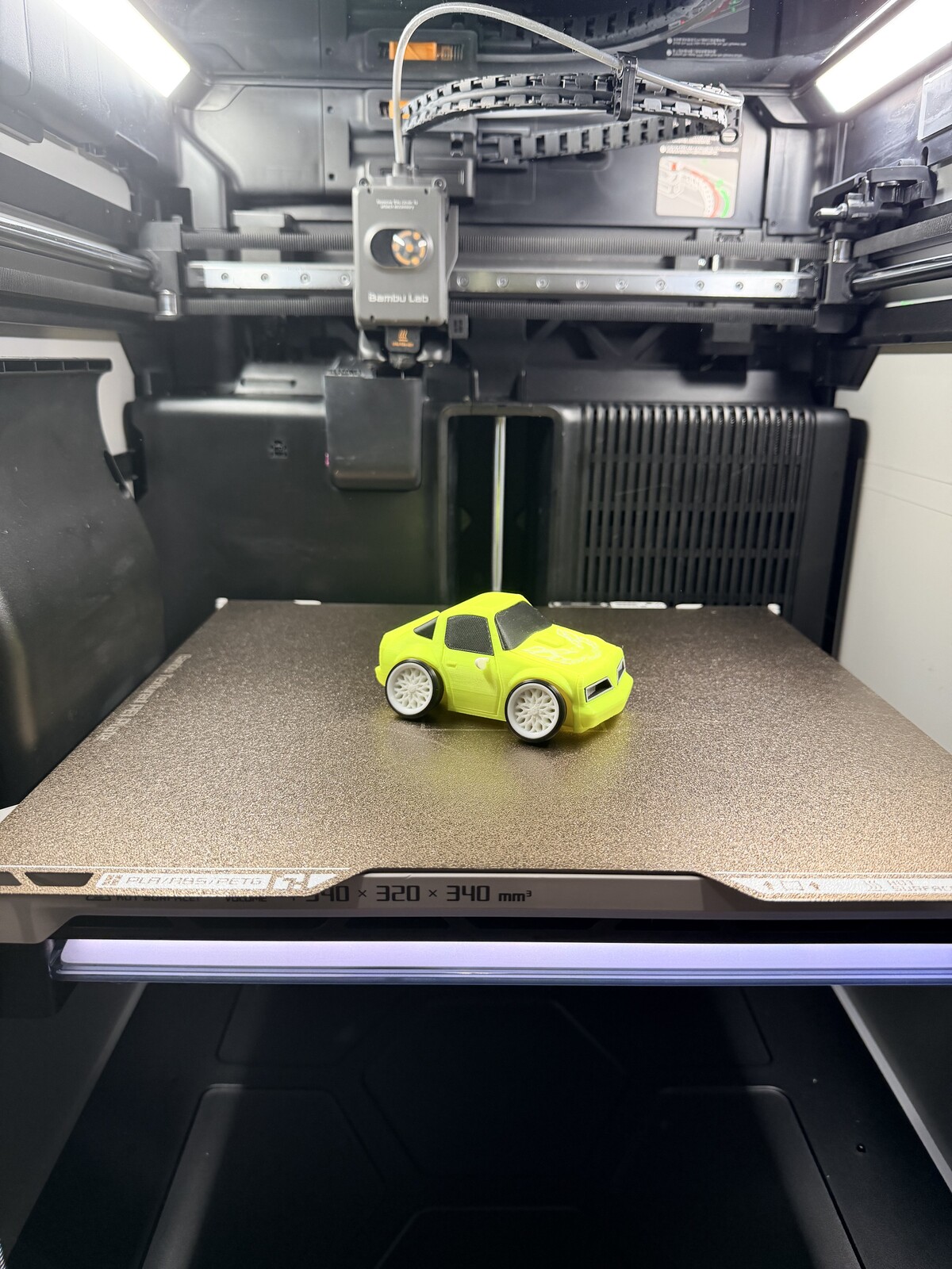 Small yellow toy car printed as a display piece