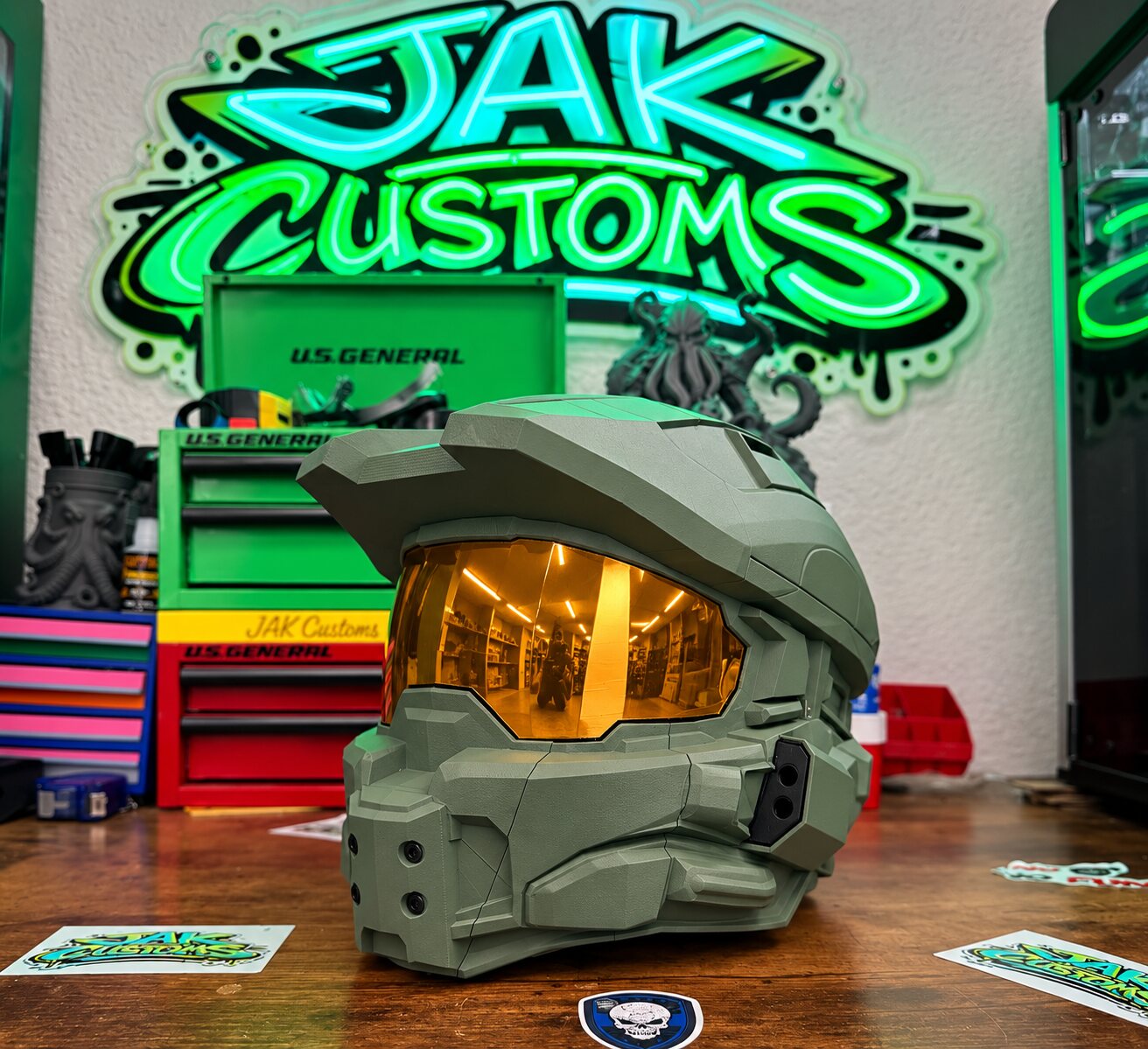 Olive green sci-fi helmet with gold visor, three-quarter view