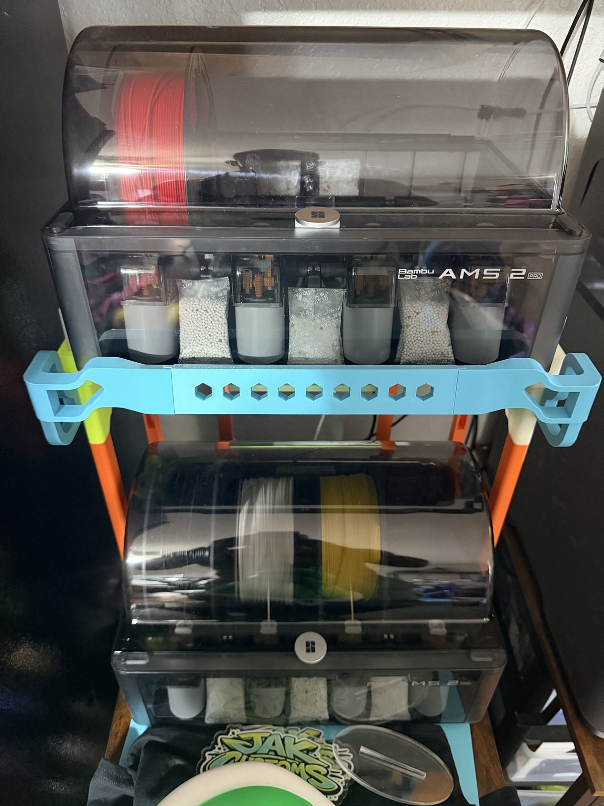 Light-blue printed bracket on the bed of a 3D printer