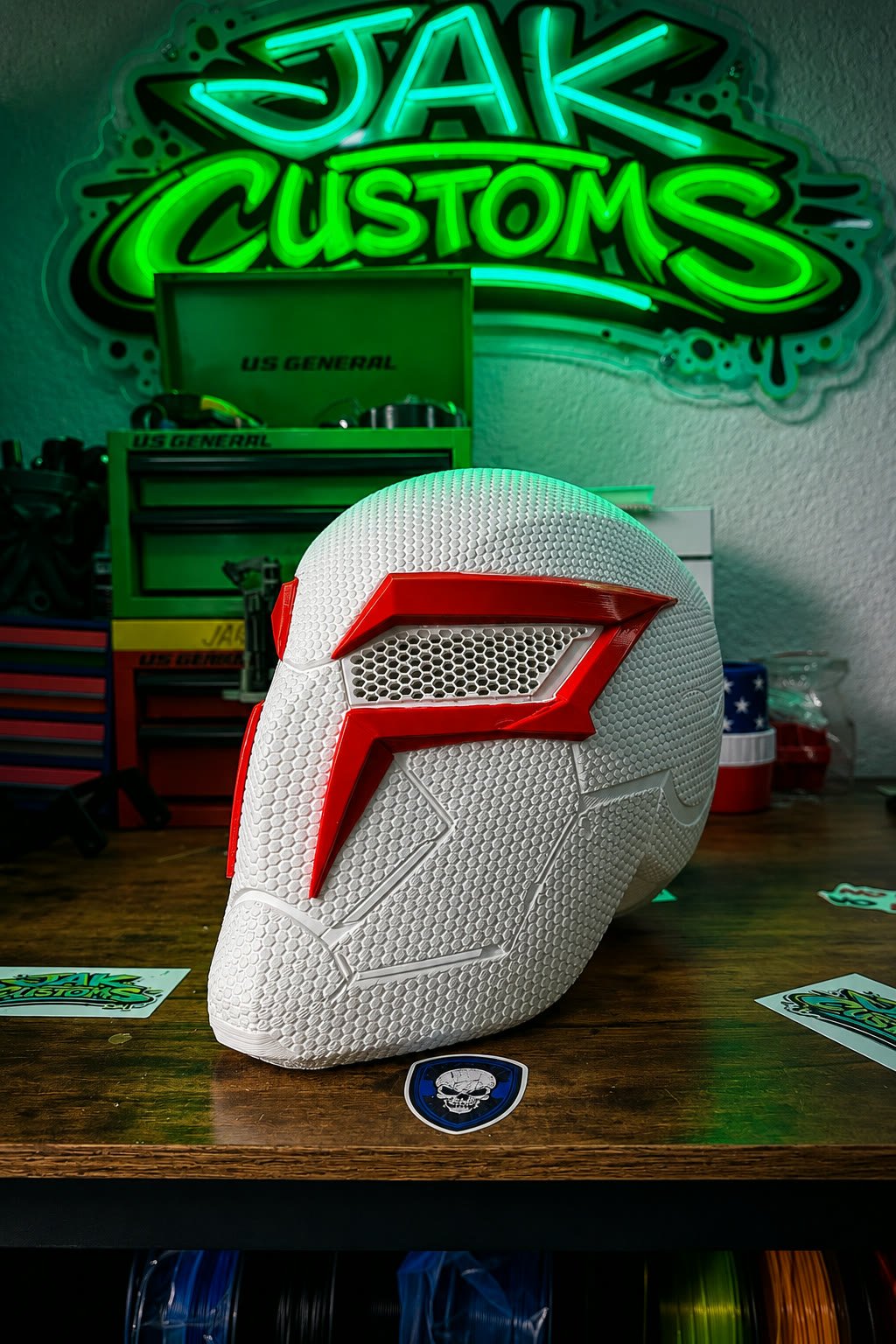 White and red helmet beside the glowing JAK Customs neon shop sign