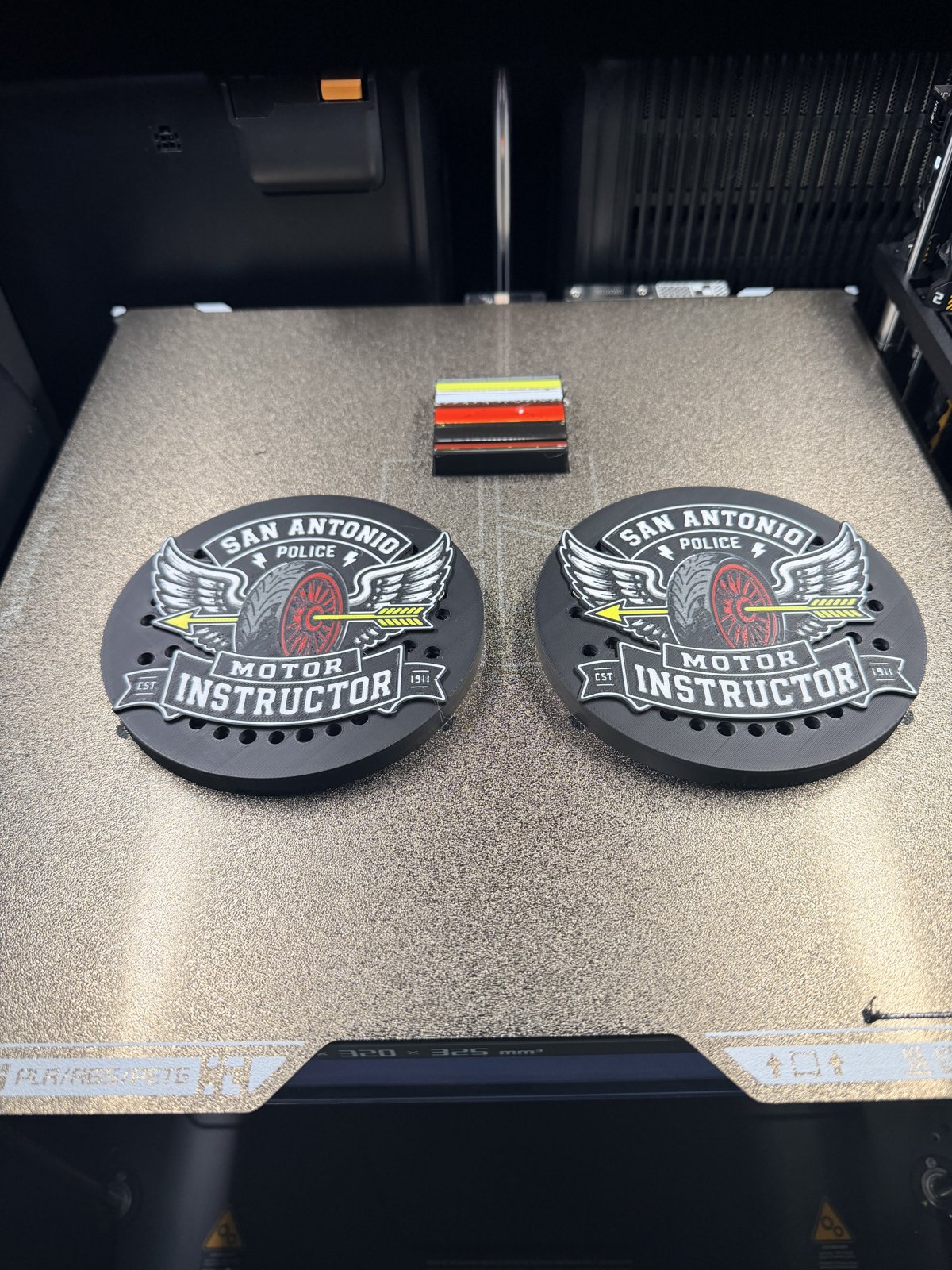 Pair of custom printed police siren covers on a printer bed
