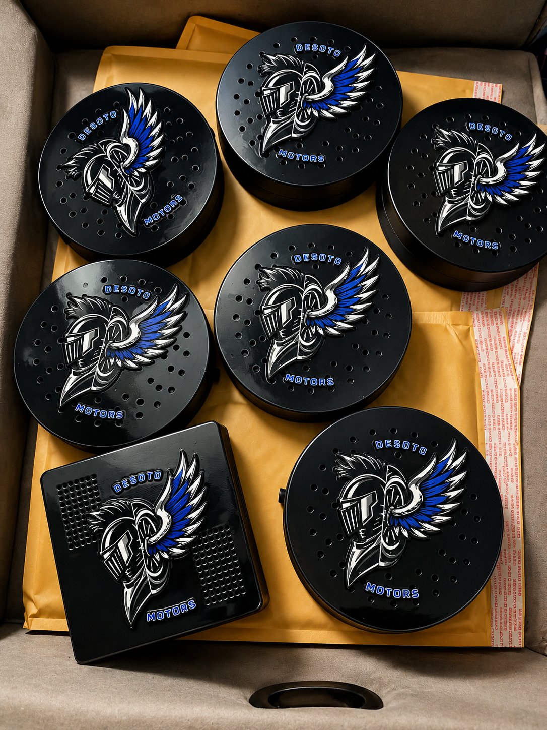 Black siren covers with silver motorcycle unit emblems arranged in a box
