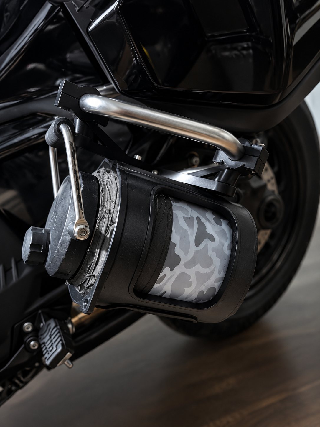 Round mounted accessory on a motorcycle shown from the side