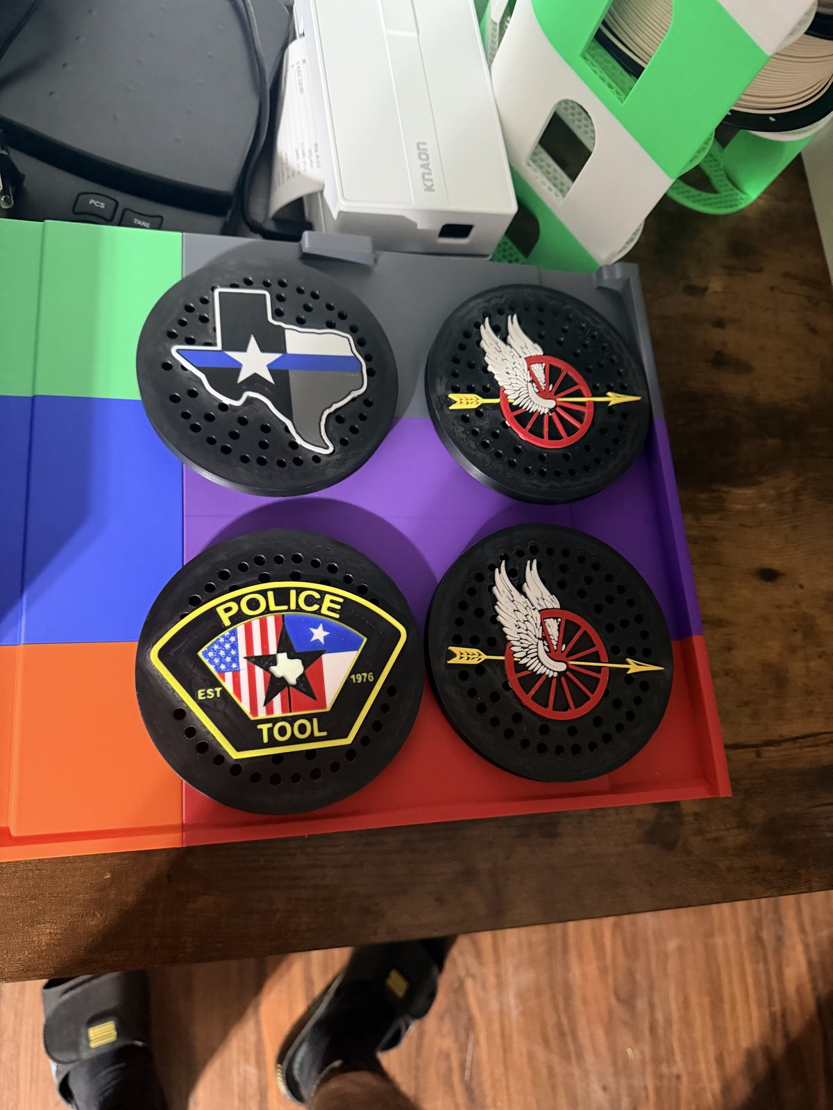 Police siren covers with unit and badge graphics on a workbench