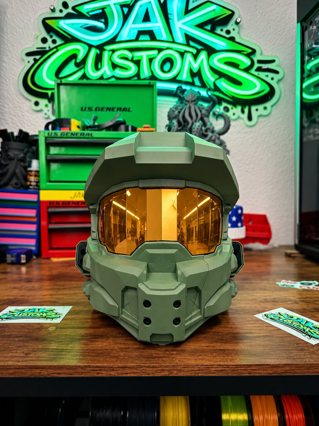 Olive green sci-fi helmet with gold visor, front view
