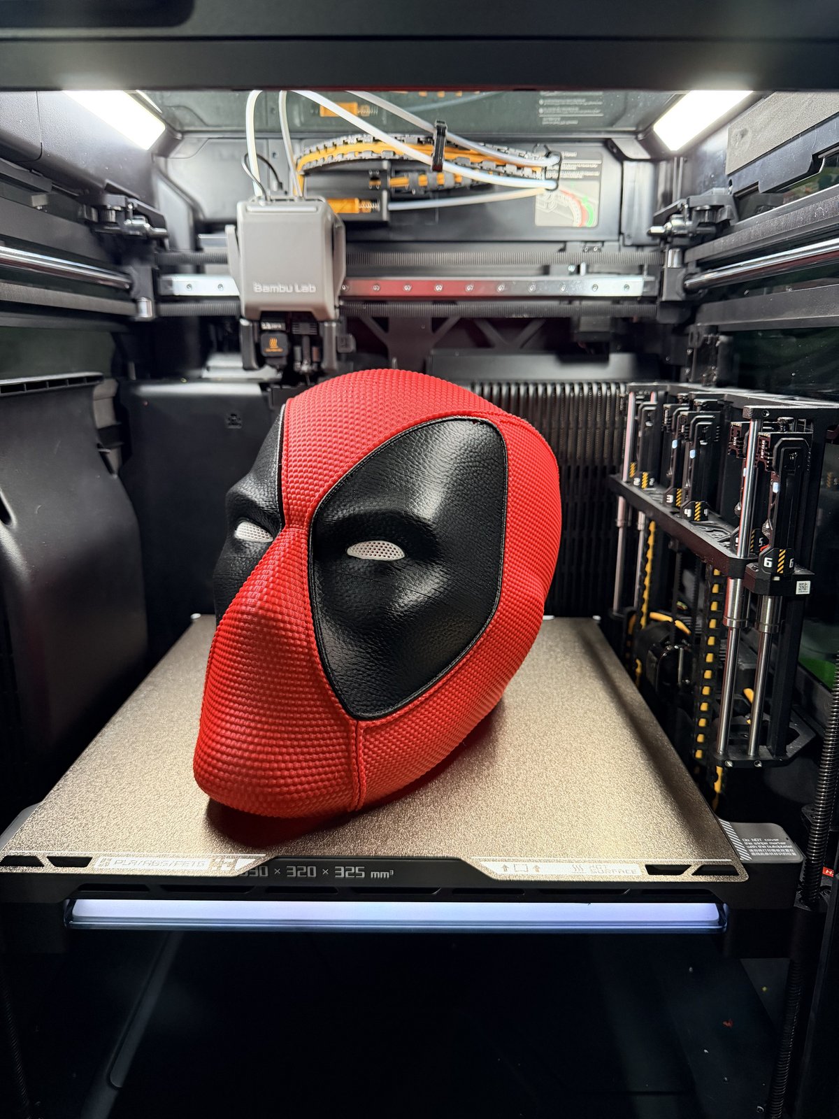 Close-up of the red and black Deadpool-style mask on the print plate