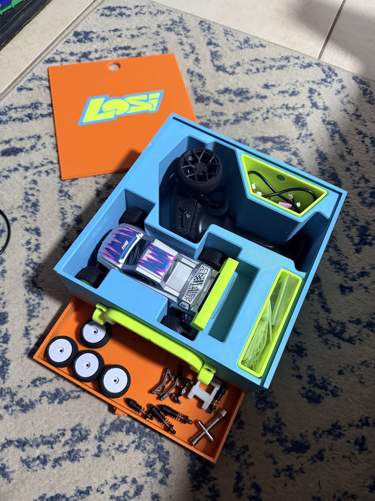 Open custom storage box with colorful fitted compartments