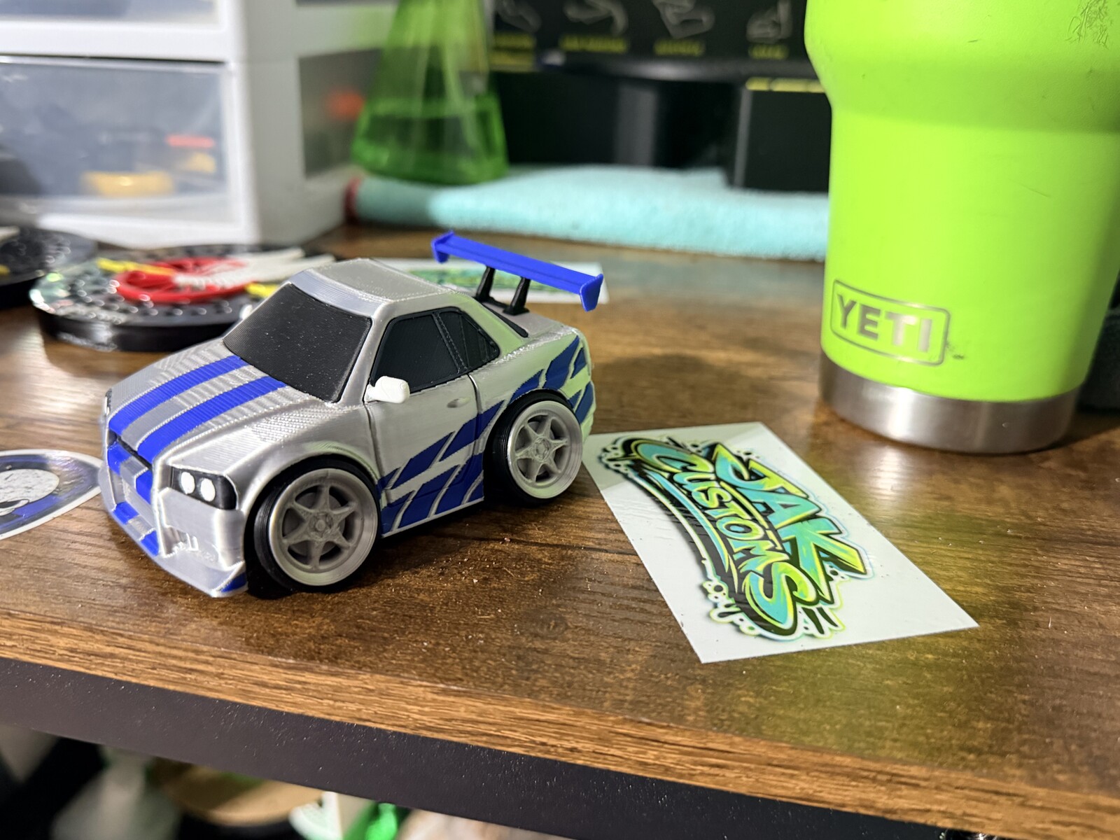 White and blue race car model with printed stripe details