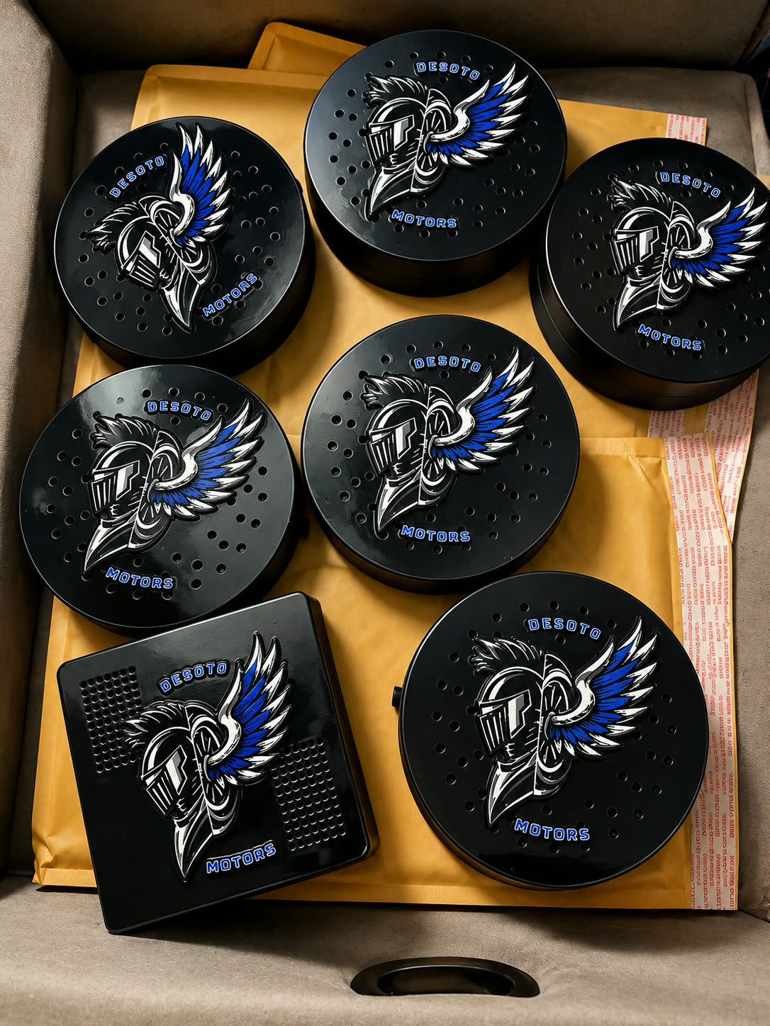 Set of printed coasters with a winged emblem design