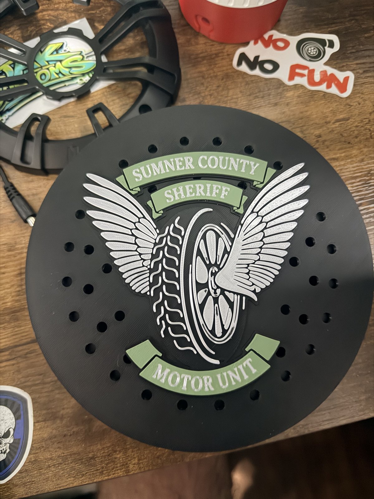 Black siren cover with silver winged motorcycle unit emblem