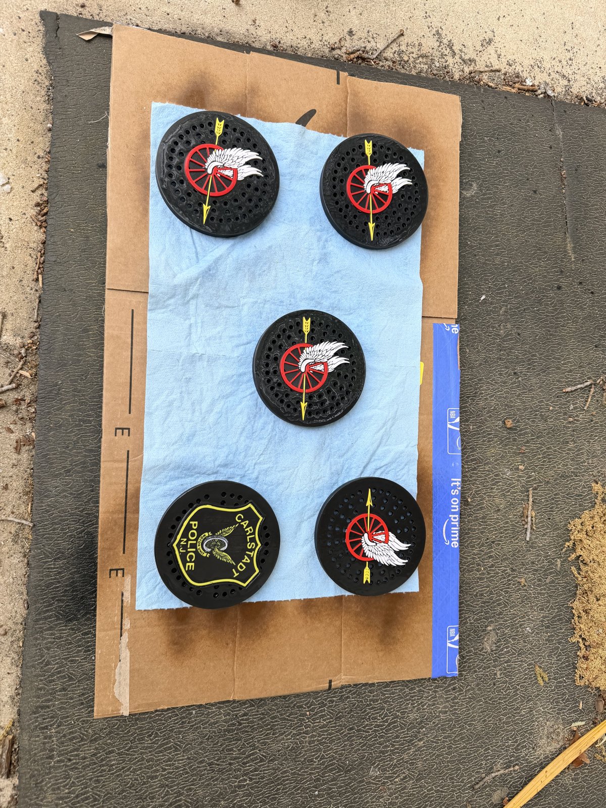 Six custom police siren covers displayed on cardboard