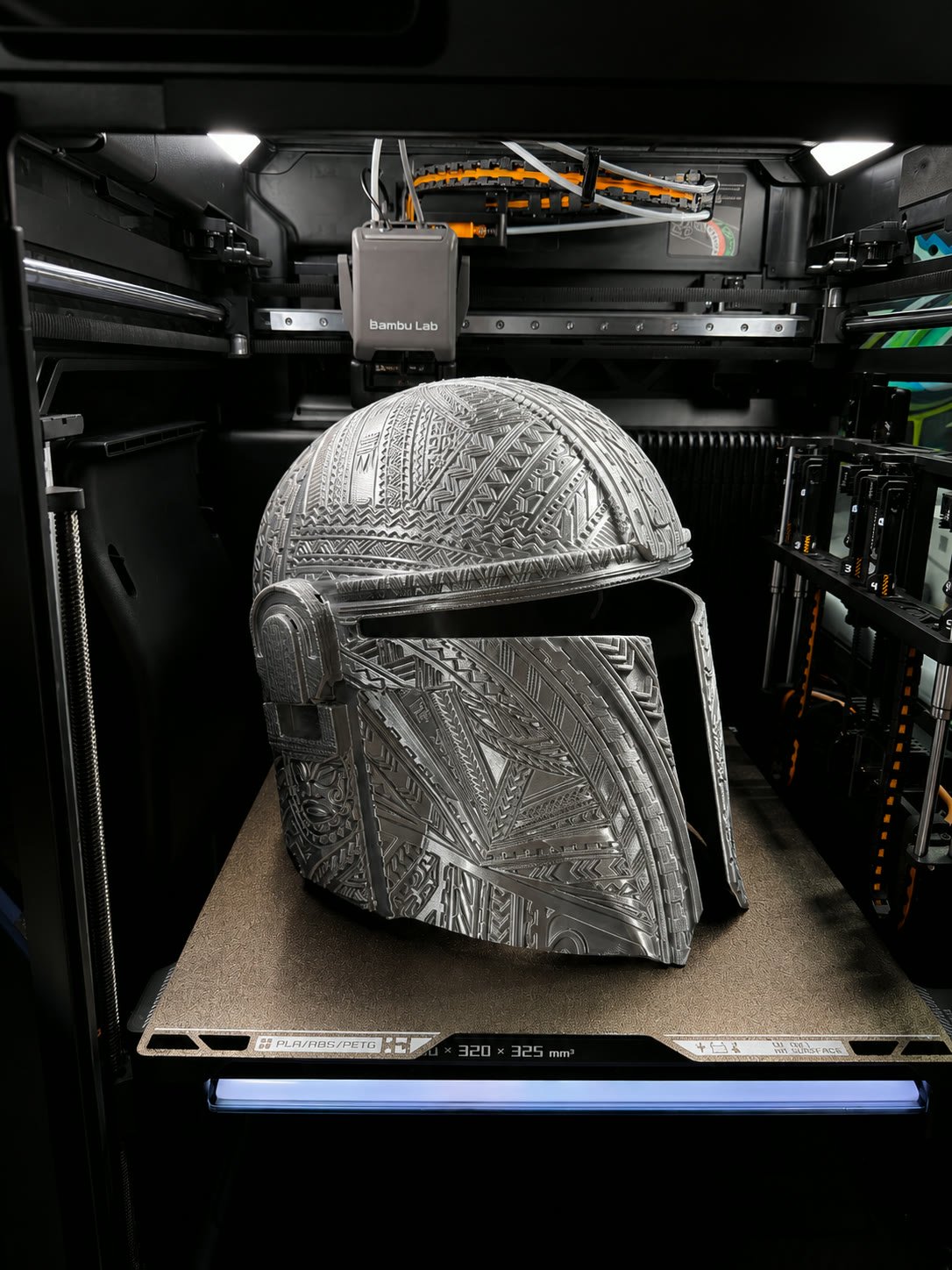 Polished silver Mandalorian-style helmet seen from the side